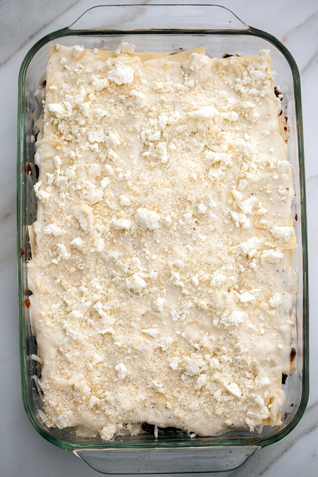 A feta bechamel, ground lamb, as el hangout, and dried apricots make this lasagna recipe extra special! | www.spachethespatula.com 