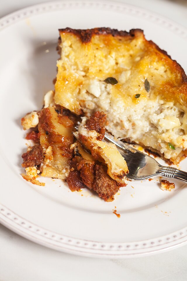 A feta bechamel, ground lamb, as el hangout, and dried apricots make this lasagna recipe extra special! | www.spachethespatula.com 