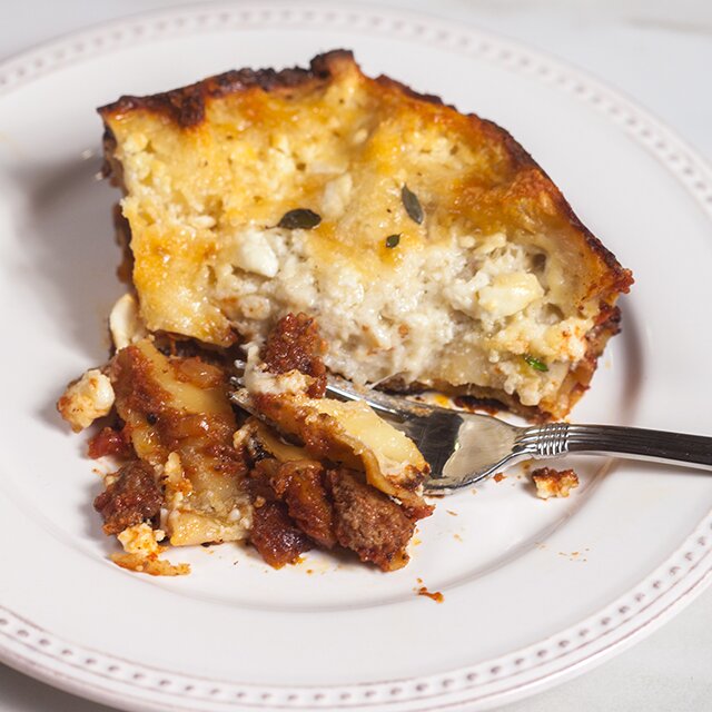 A feta bechamel, ground lamb, as el hangout, and dried apricots make this lasagna recipe extra special! | www.spachethespatula.com 