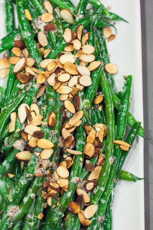 Crisp green beans are coated with a creamy, herby, whole grain mustard sauce, and topped with crunchy toasted almonds, and ready in 5 minutes! | www.spachethespatula.com #recipe