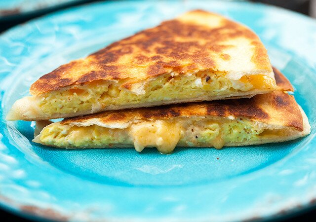 Creamy, cheesy scrambled eggs stuffed inside a crisp, golden brown tortilla! | www.spachethespatula.com #recipe