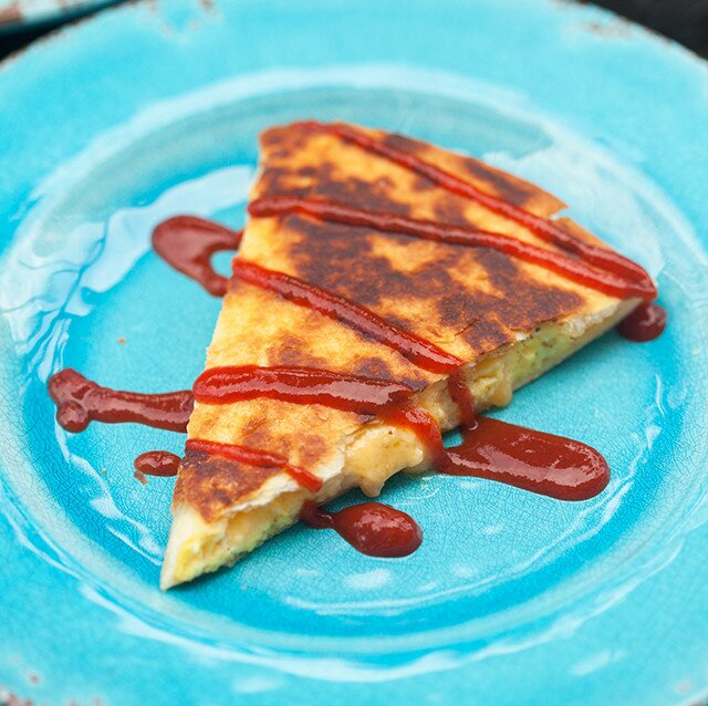 Creamy, cheesy scrambled eggs stuffed inside a crisp, golden brown tortilla! | www.spachethespatula.com #recipe